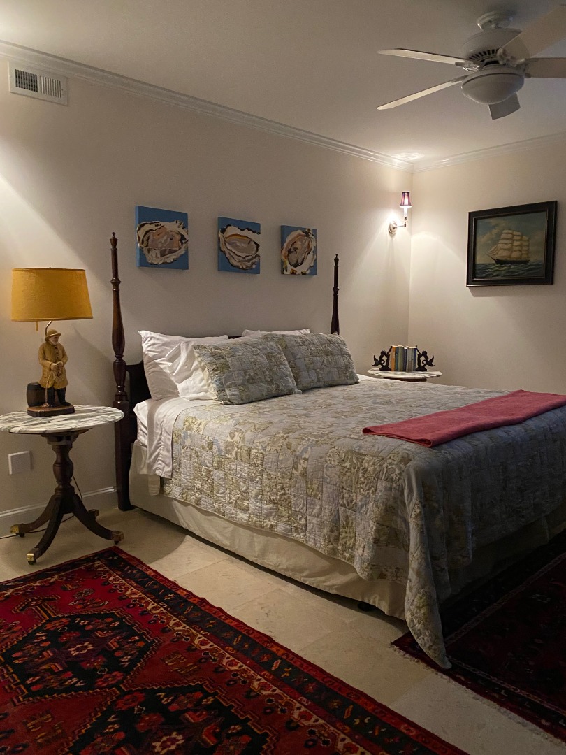 12 Spring Street Vineyard Haven, MA 02568 - Photo 35 of 40 a bedroom with a bed and lamp on dresser