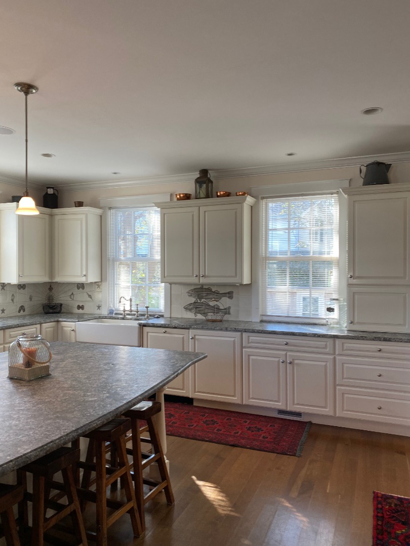12 Spring Street Vineyard Haven, MA 02568 - Photo 37 of 40 a kitchen with granite countertop a stove a sink and cabinets