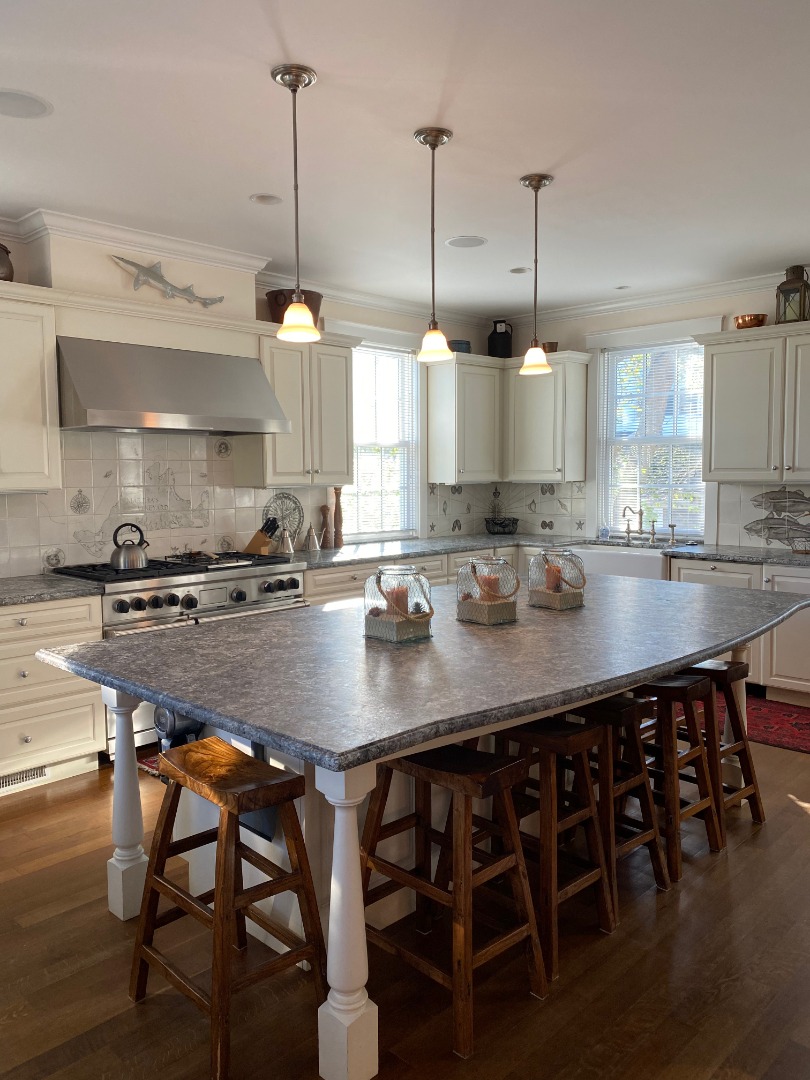 12 Spring Street Vineyard Haven, MA 02568 - Photo 38 of 40 a kitchen with a table and chairs in it