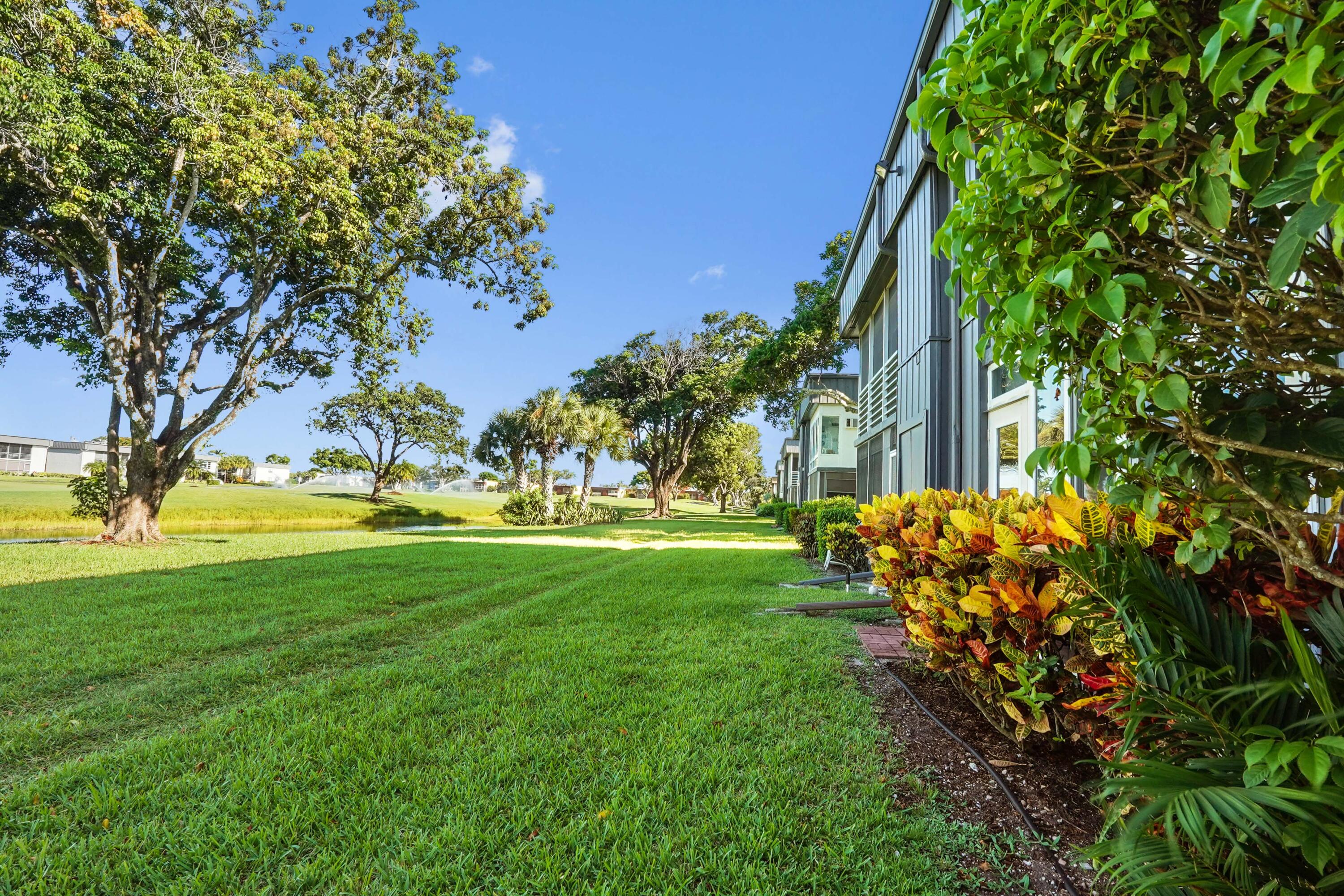 16 Normandy A Delray Beach, FL 33484 - Photo 30 of 46 a view of yard with swimming pool and green space