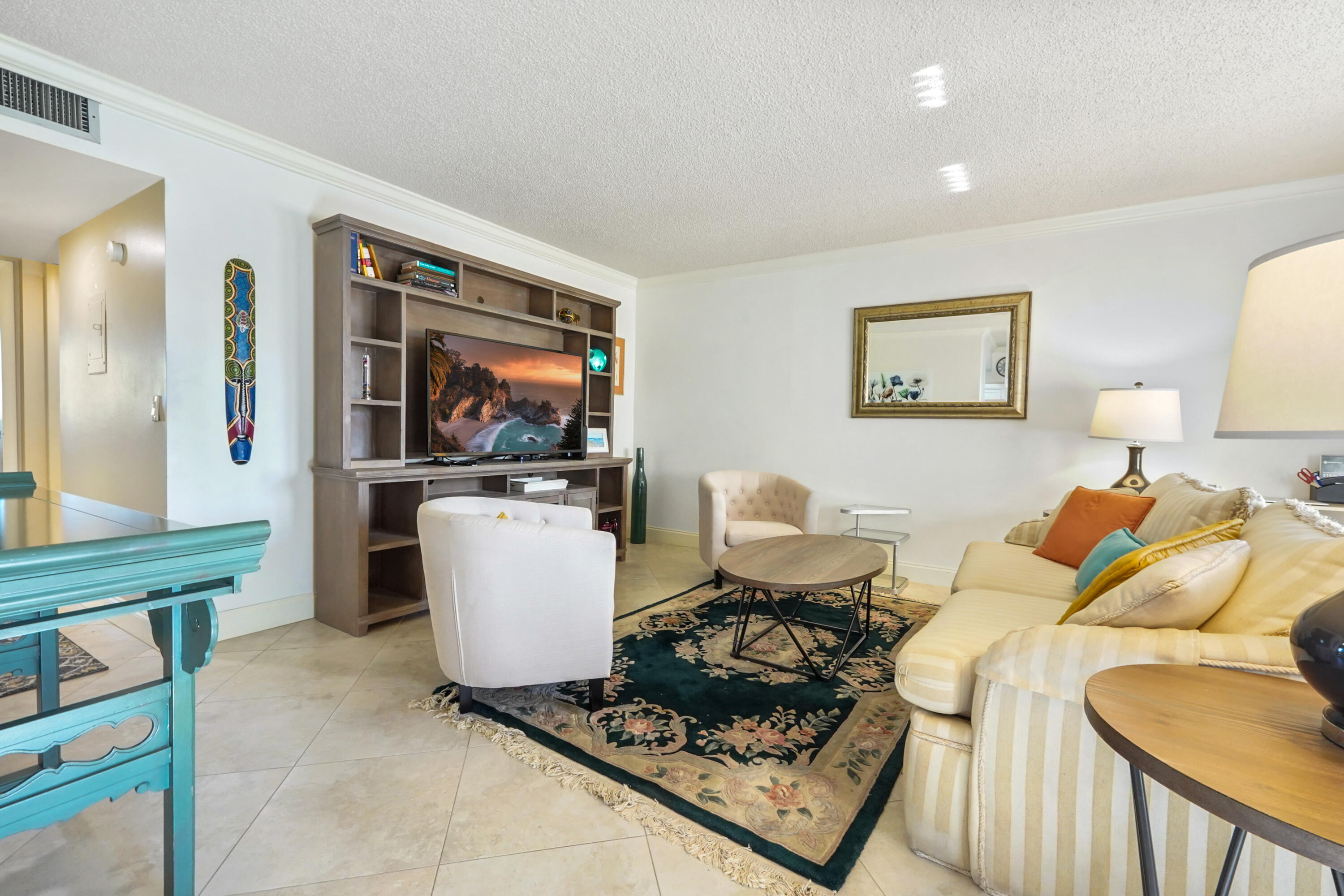 16 Normandy A Delray Beach, FL 33484 - Photo 7 of 46 a living room with furniture and a flat screen tv