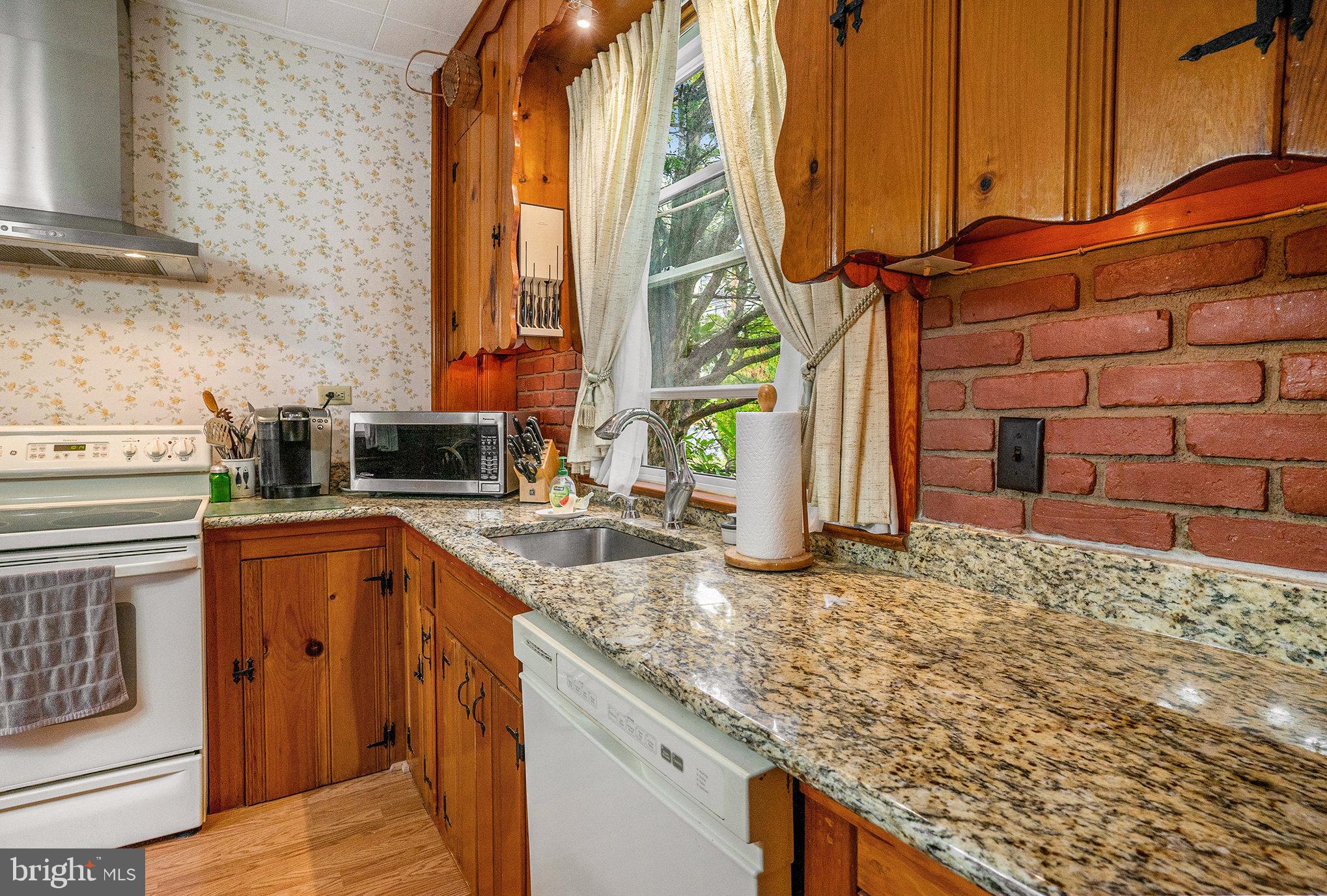 1640 Walnut Avenue Oreland, PA 19075 - Photo 18 of 45 a kitchen with stainless steel appliances granite countertop a sink and a stove