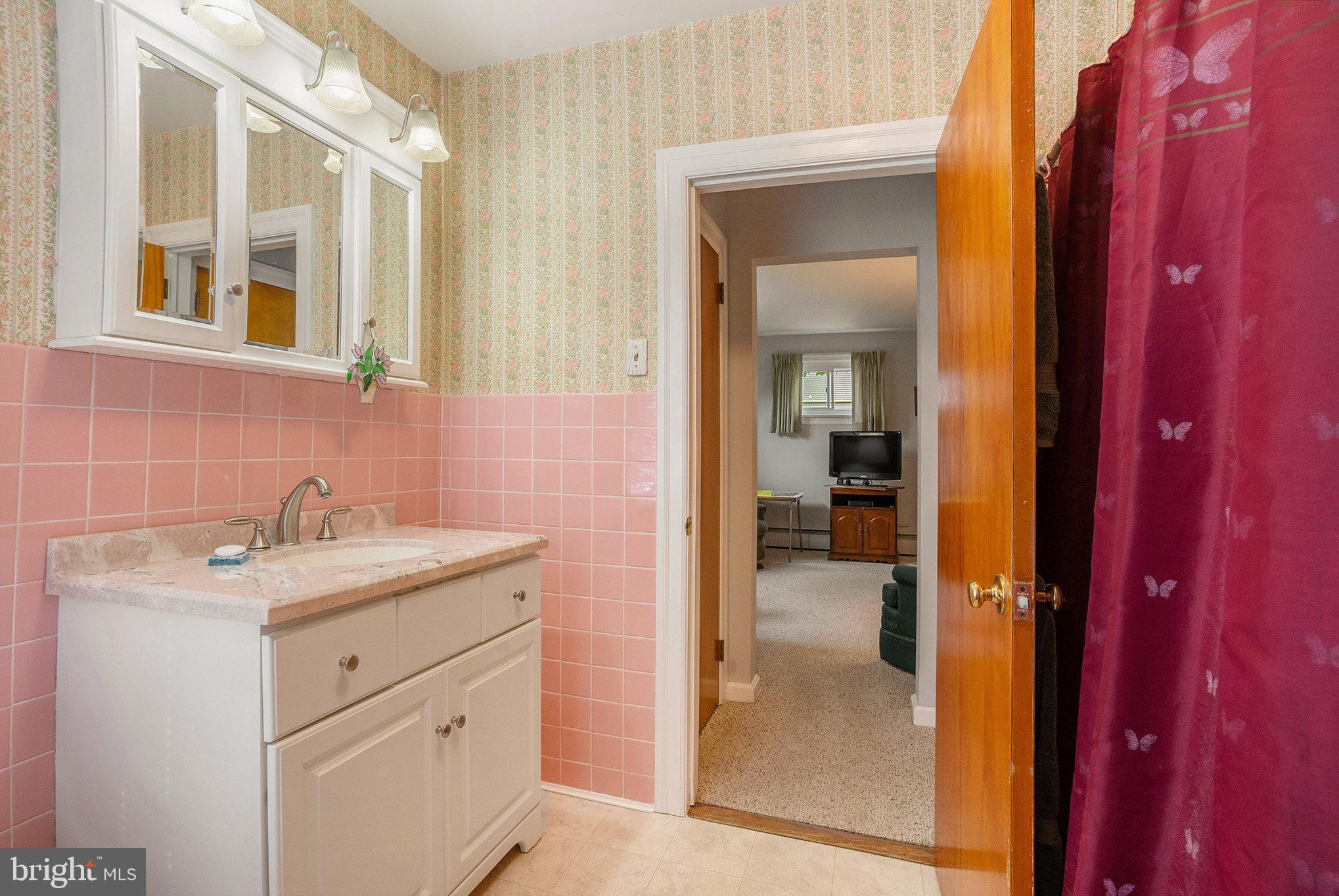 1640 Walnut Avenue Oreland, PA 19075 - Photo 21 of 45 a en suite bathroom with a sink a mirror and a shower
