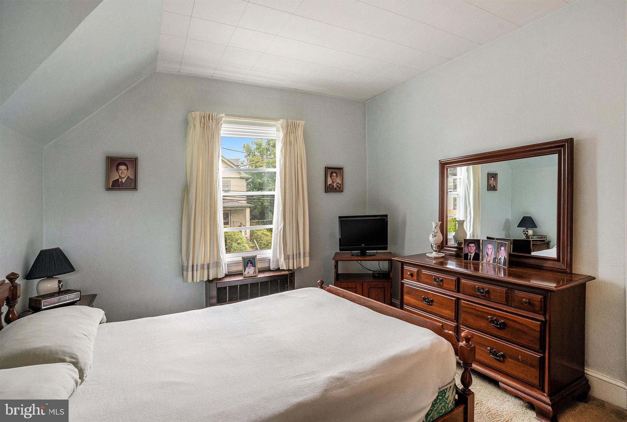 1640 Walnut Avenue Oreland, PA 19075 - Photo 29 of 45 a bedroom with a bed and a flat screen tv