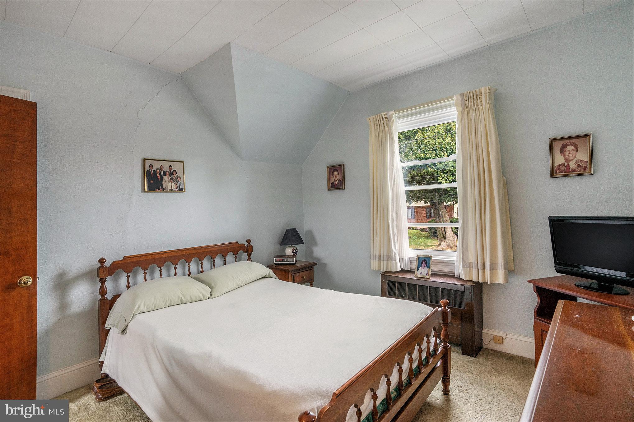 1640 Walnut Avenue Oreland, PA 19075 - Photo 30 of 45 a bedroom with a bed and a flat screen tv