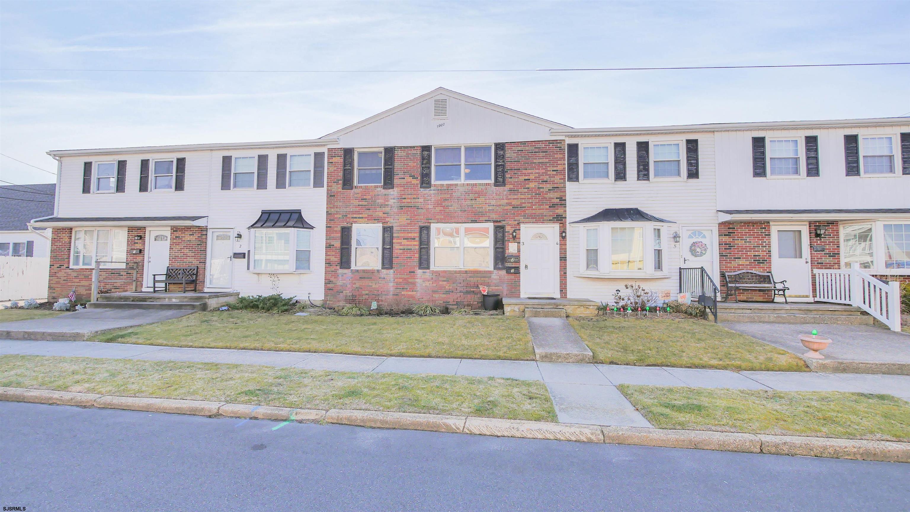 1000 West Brigantine Avenue, Unit 4 Brigantine, NJ 08203 - Photo 1 of 19 a front view of a house with a yard and lake view