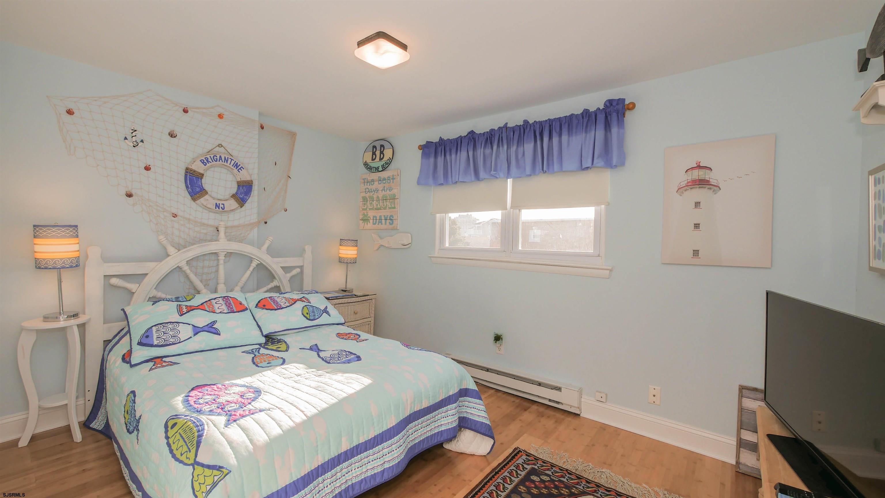 1000 West Brigantine Avenue, Unit 4 Brigantine, NJ 08203 - Photo 12 of 19 a bedroom with furniture and a window