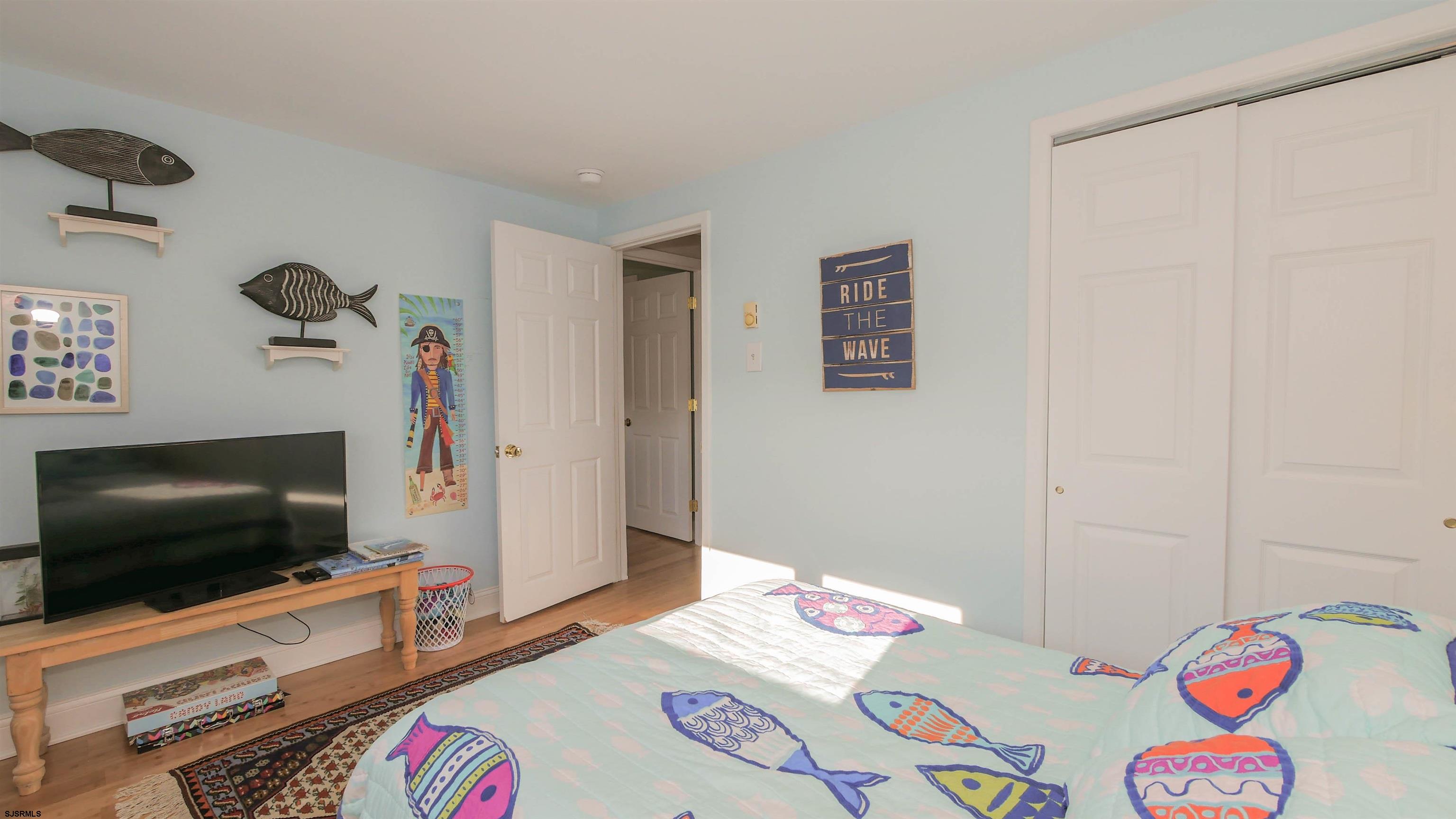 1000 West Brigantine Avenue, Unit 4 Brigantine, NJ 08203 - Photo 13 of 19 a room with furniture and a flat screen tv