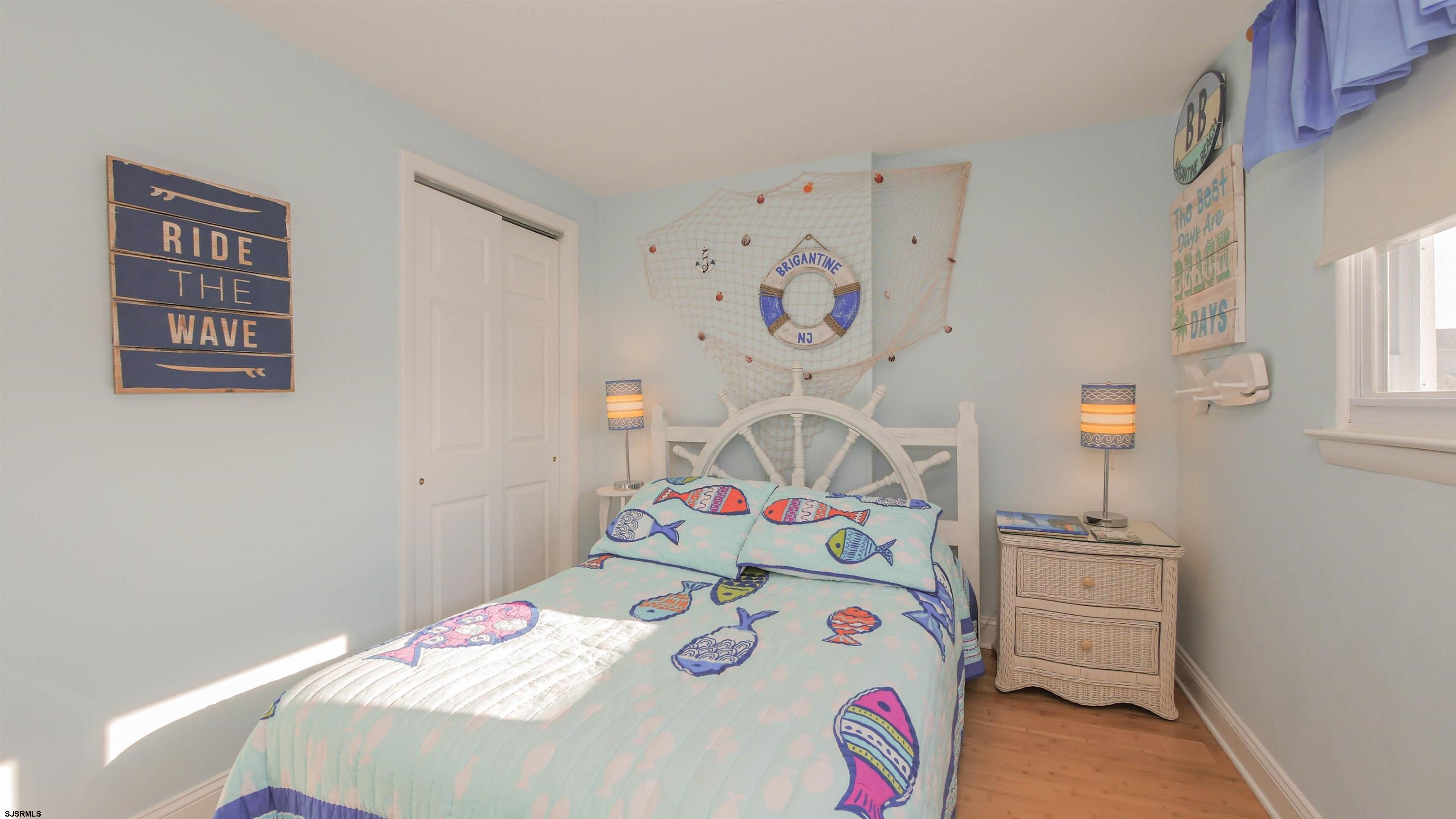 1000 West Brigantine Avenue, Unit 4 Brigantine, NJ 08203 - Photo 14 of 19 a bedroom with a bed and cabinets