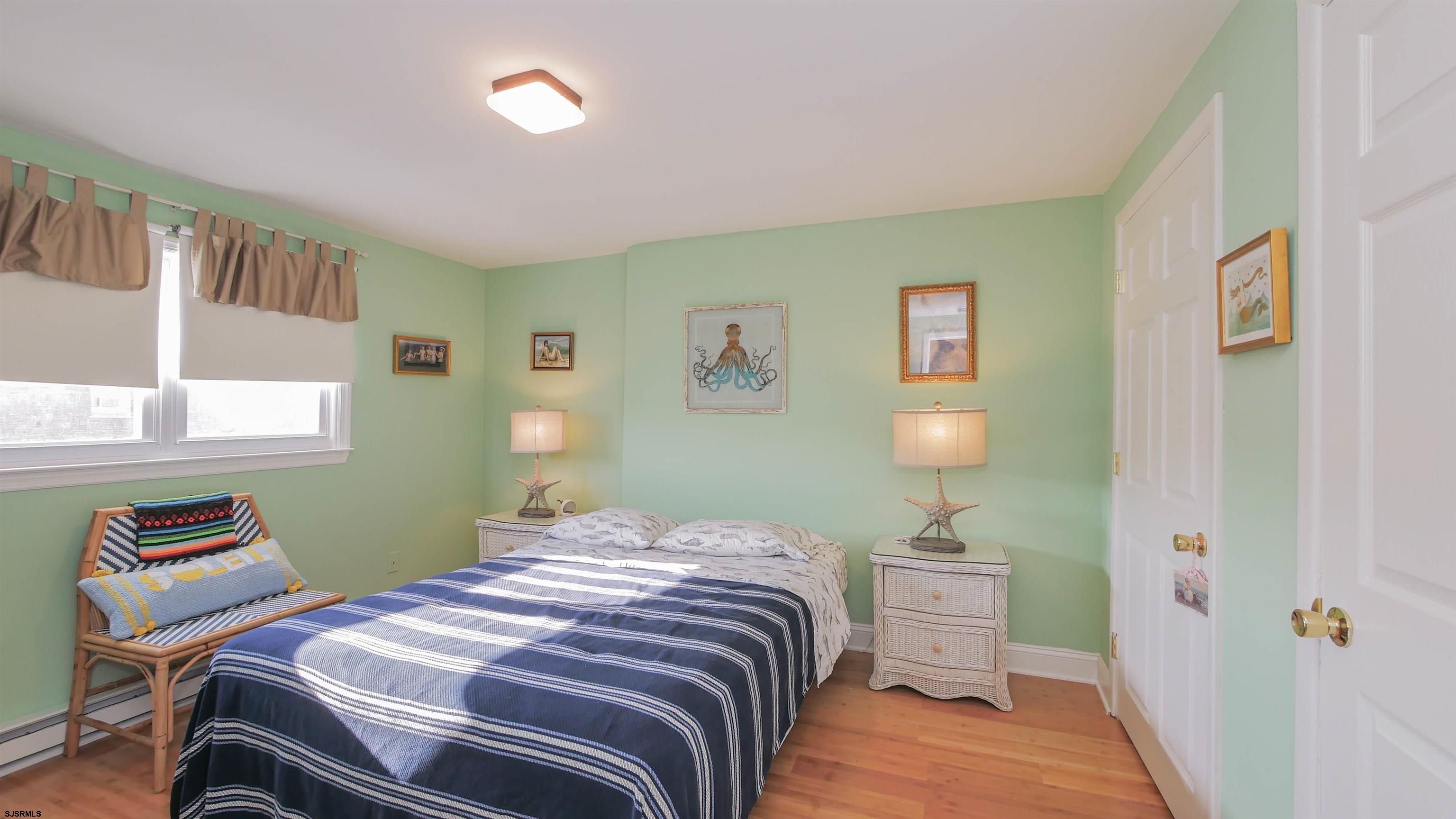 1000 West Brigantine Avenue, Unit 4 Brigantine, NJ 08203 - Photo 15 of 19 a bedroom with a bed and a window