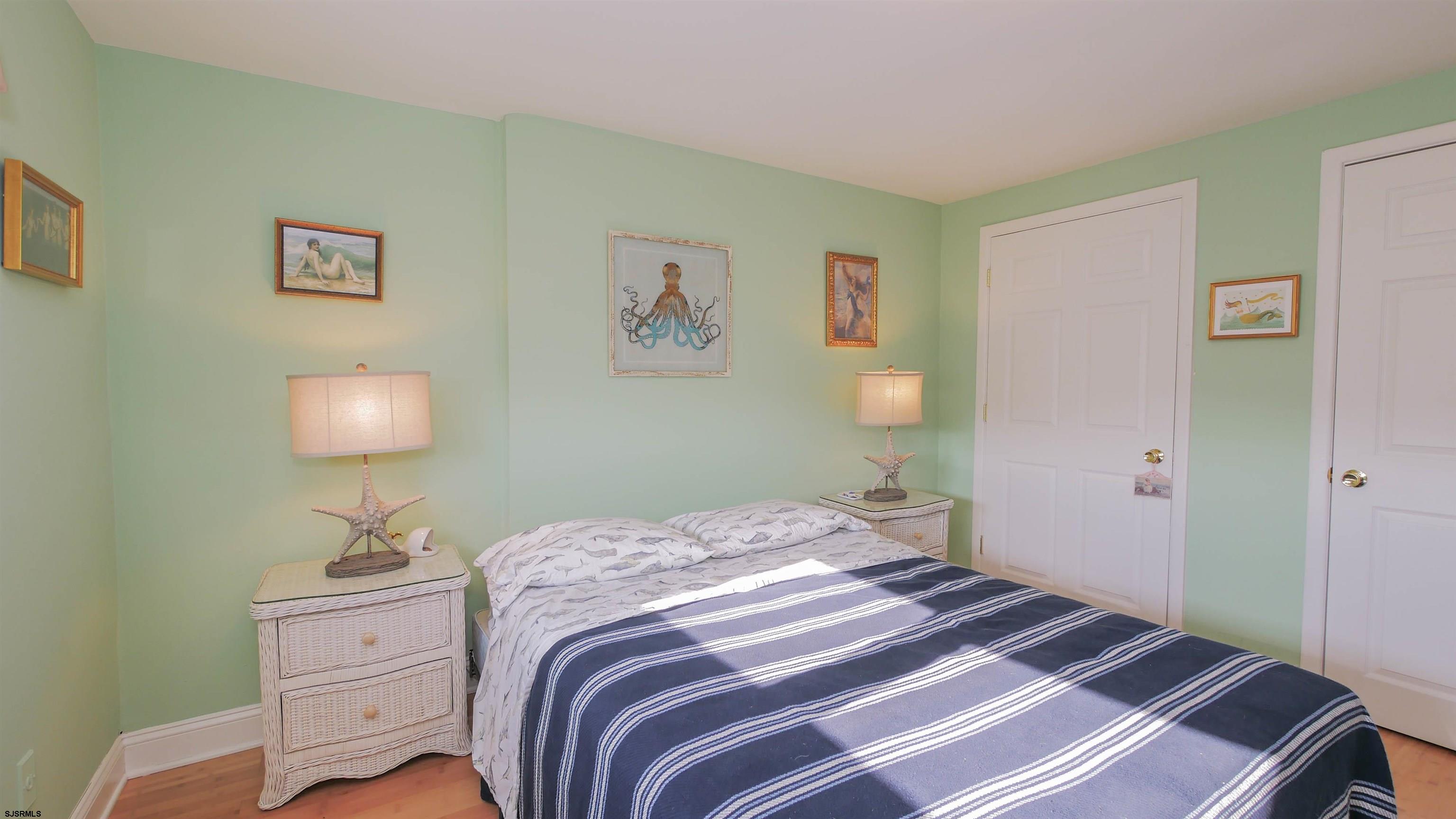 1000 West Brigantine Avenue, Unit 4 Brigantine, NJ 08203 - Photo 16 of 19 a bedroom with a bed and a lamp on table