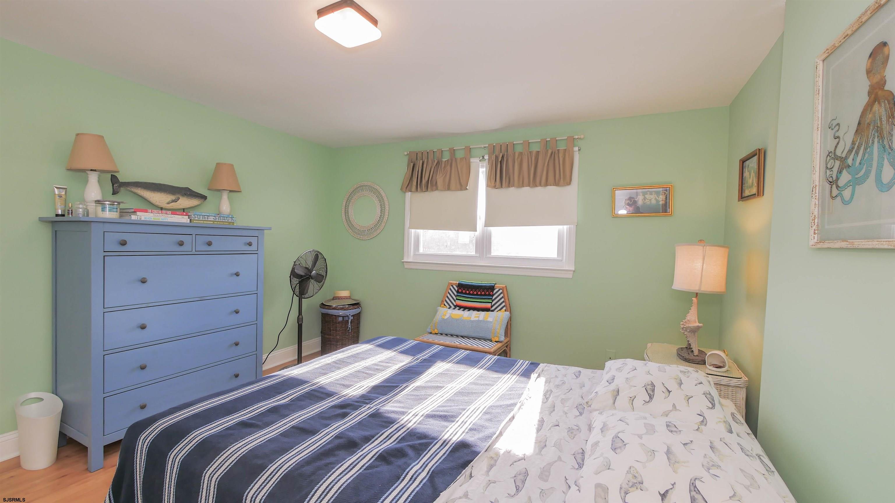 1000 West Brigantine Avenue, Unit 4 Brigantine, NJ 08203 - Photo 17 of 19 a bedroom with a bed and a dresser