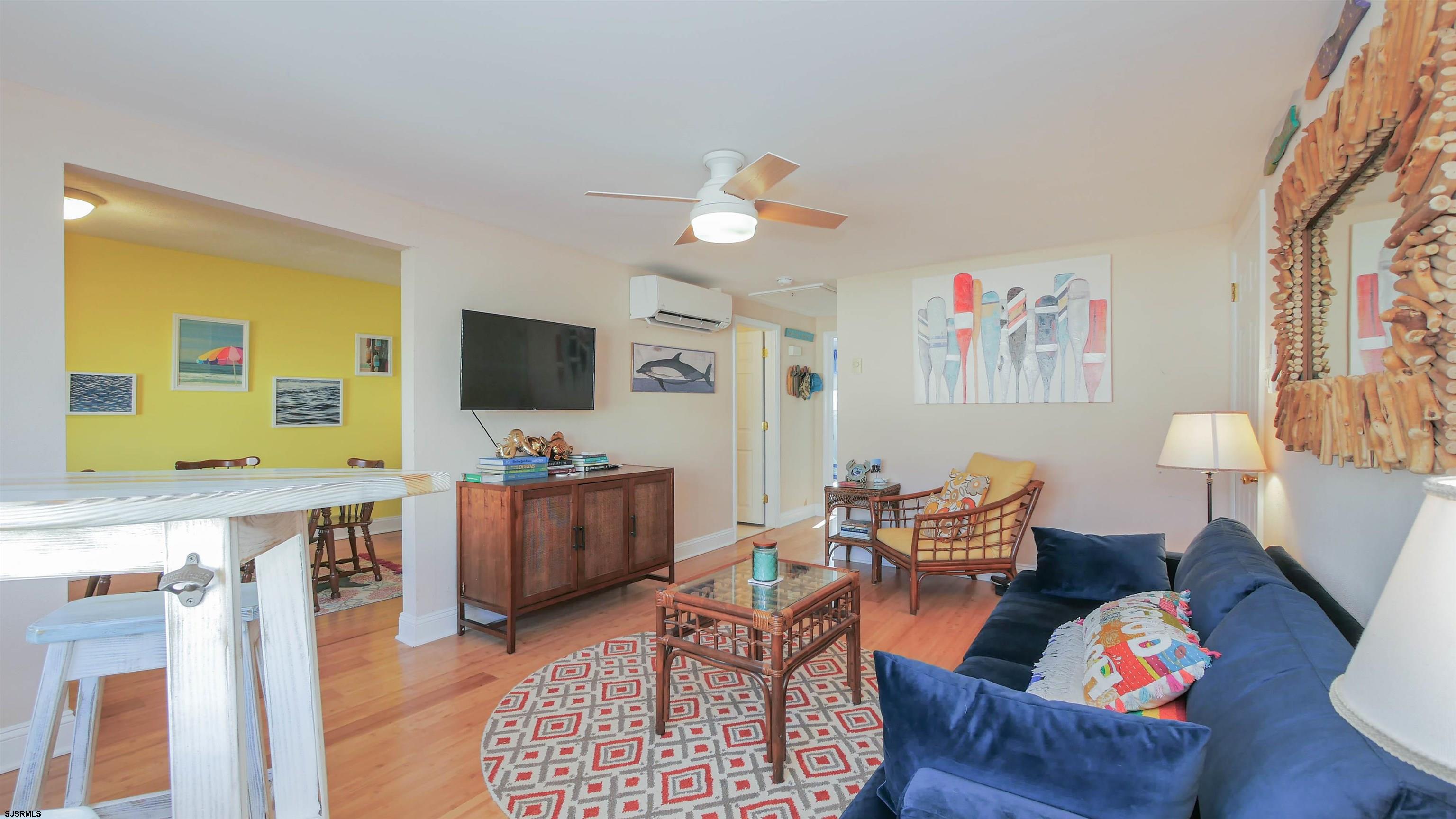 1000 West Brigantine Avenue, Unit 4 Brigantine, NJ 08203 - Photo 3 of 19 a living room with furniture and a flat screen tv
