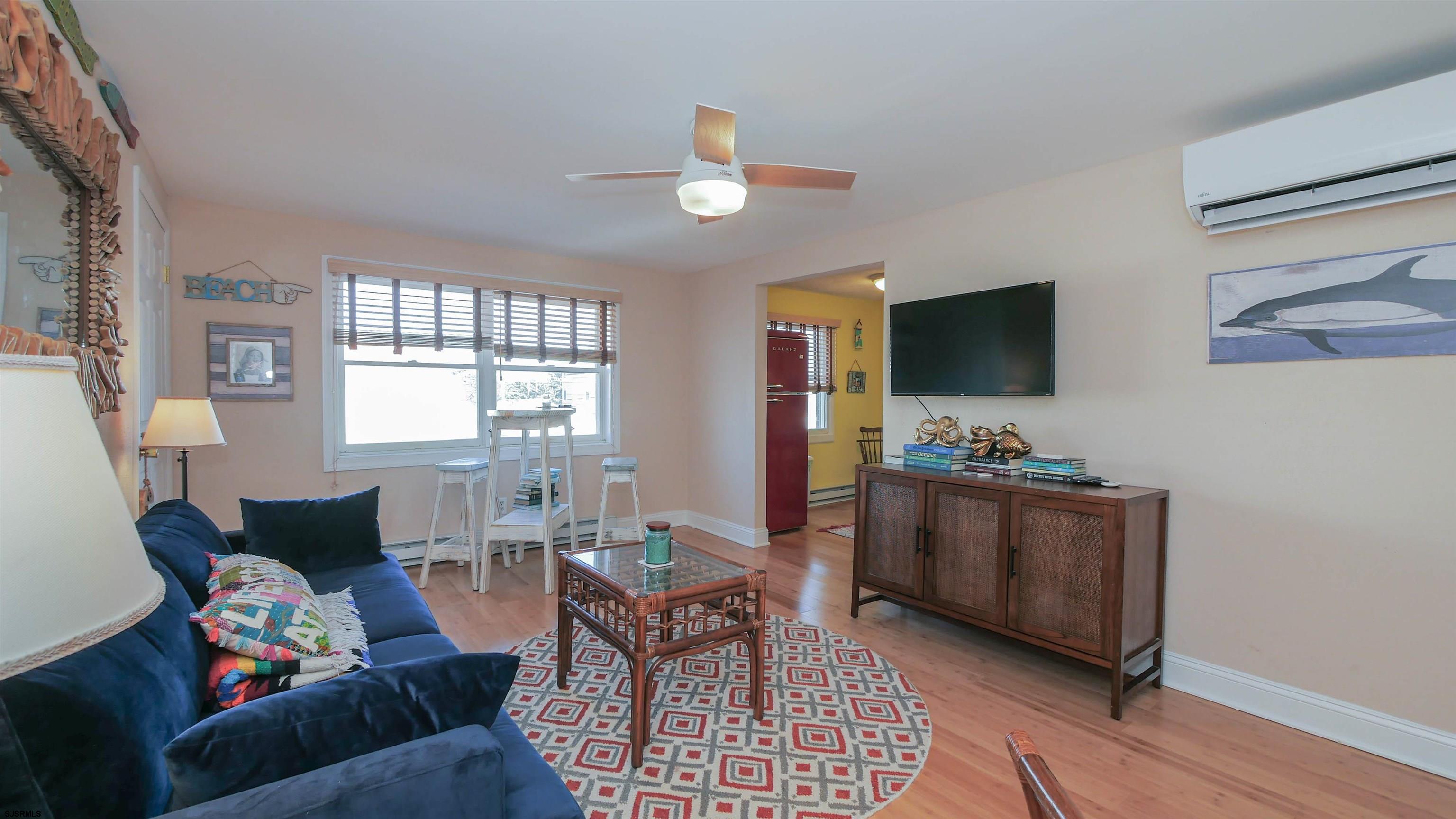1000 West Brigantine Avenue, Unit 4 Brigantine, NJ 08203 - Photo 4 of 19 a living room with furniture and a flat screen tv