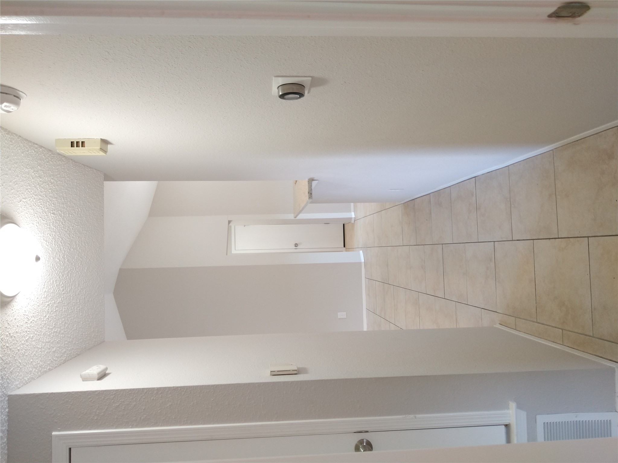 1813 Laurel Path Round Rock, TX 78664 - Photo 22 of 35 A well-lit corridor with vaulted ceilings and ceramic tile flooring connects living spaces.