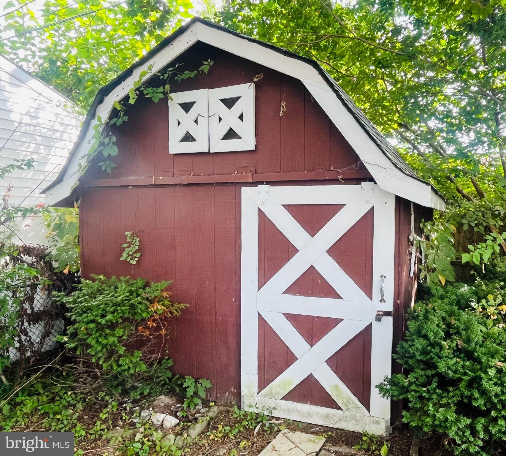 1319 Meadowvale Road Glen Burnie, MD 21060 - Photo 15 of 15 Charming rustic shed nestled in greenery.