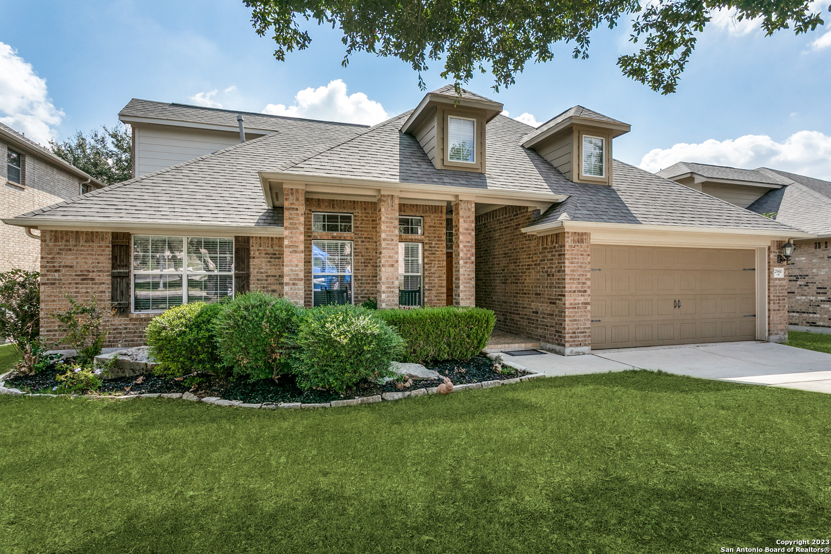 front view of a house with a yard