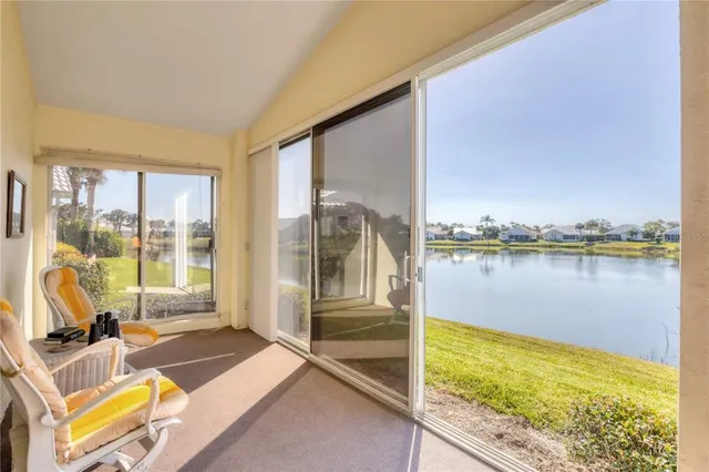 a dining room with furniture and large windows