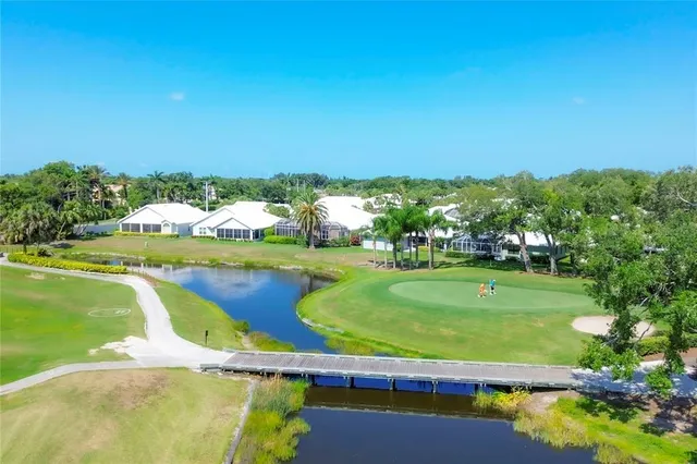 an aerial view of a houses with a lake view