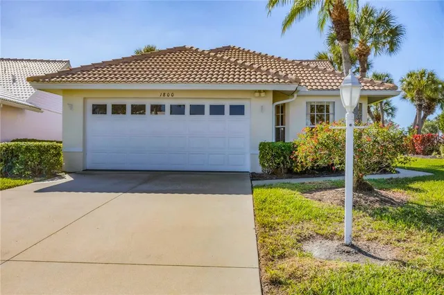 a living room with furniture a lamp and a flat screen tv