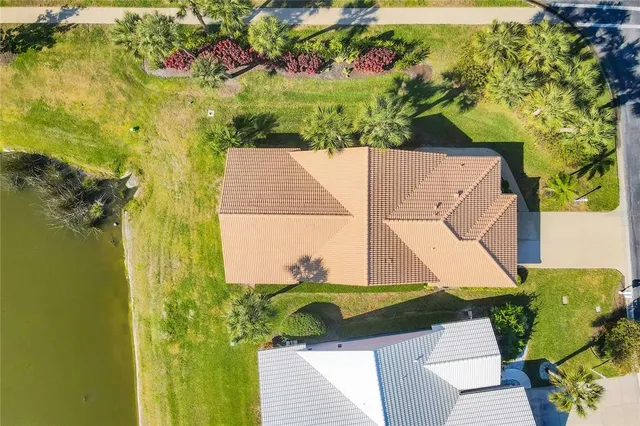 a spacious bedroom with a balcony a bed a couch and a flat tv screen on the dresser