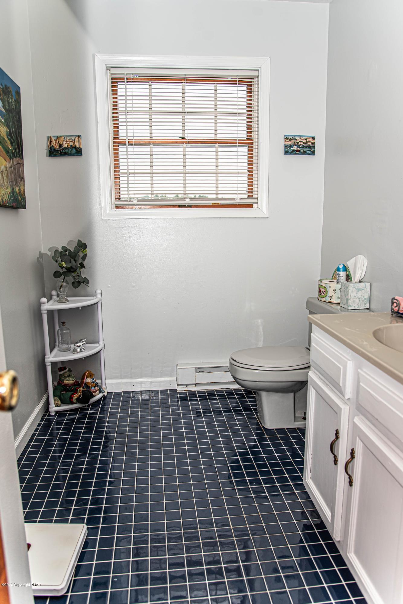 187 Old Stagecoach Road Gilbert, PA 18331 - Photo 12 of 31 a bathroom with a toilet a sink and a window