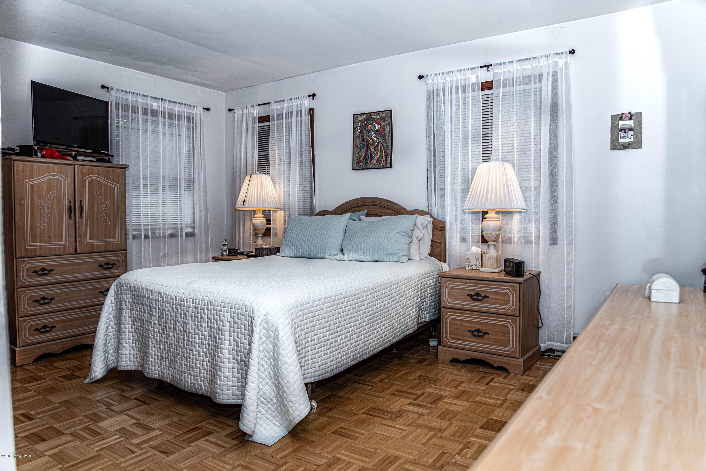 187 Old Stagecoach Road Gilbert, PA 18331 - Photo 15 of 31 a bedroom with a bed and a flat tv screen on dresser