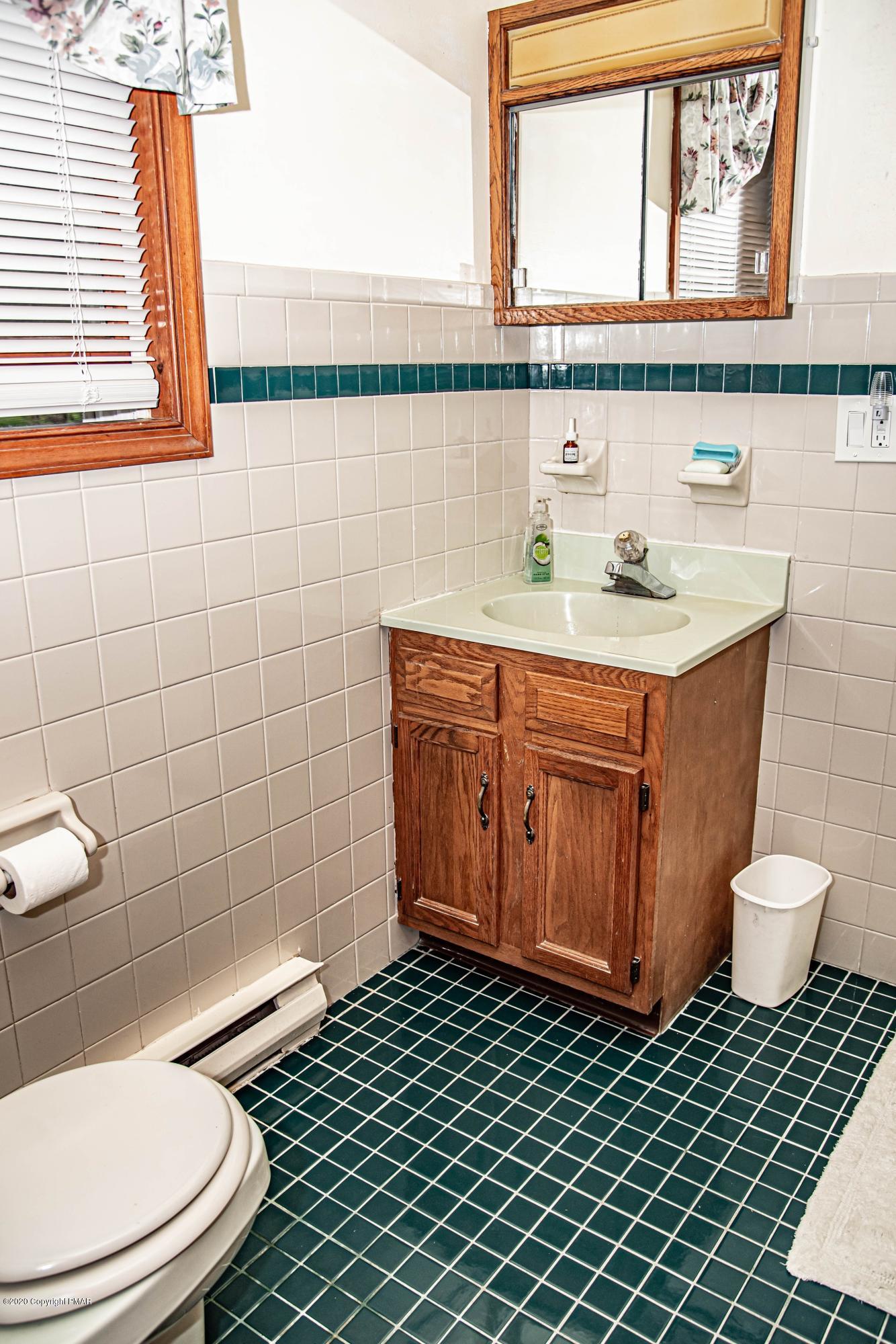 187 Old Stagecoach Road Gilbert, PA 18331 - Photo 16 of 31 a bathroom with a toilet a sink and a window