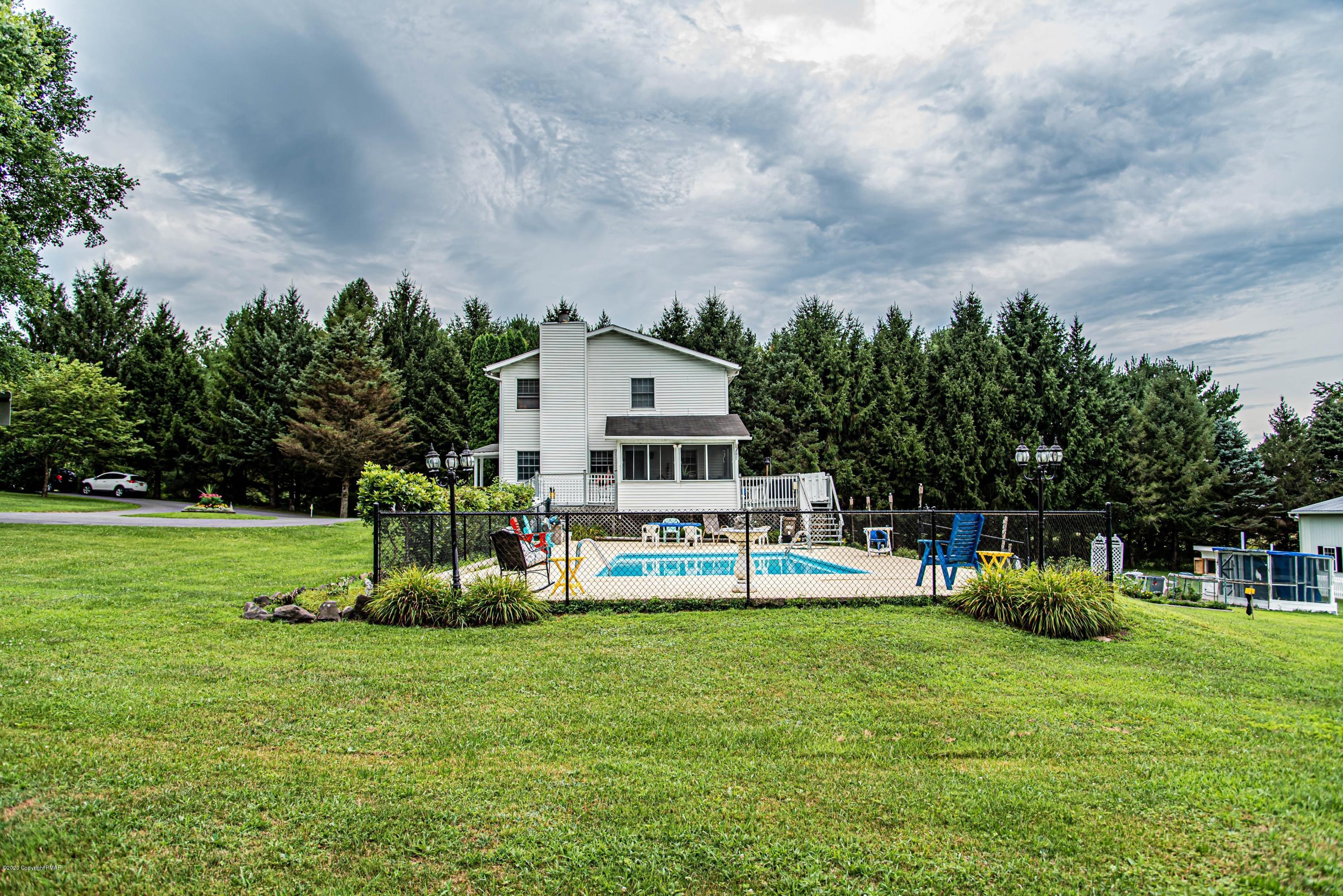 187 Old Stagecoach Road Gilbert, PA 18331 - Photo 20 of 31 a view of a house with a big yard and sitting area