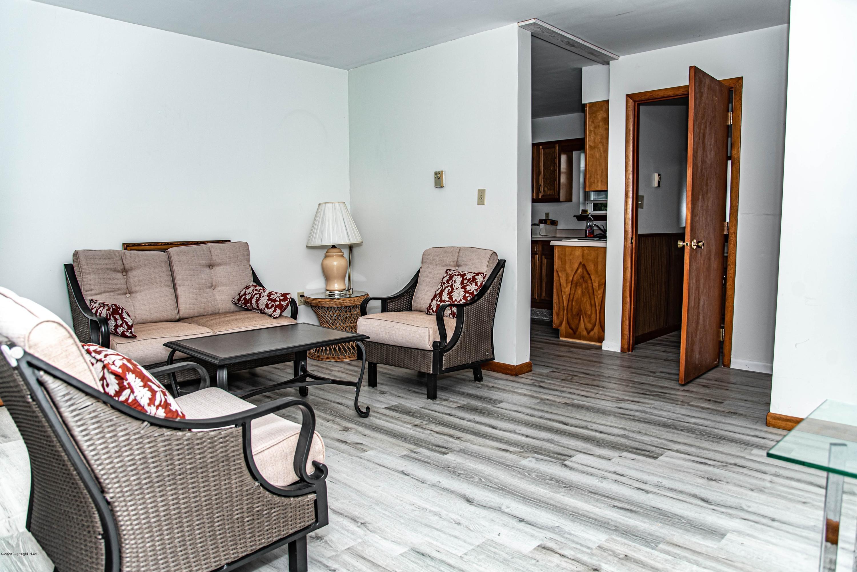 187 Old Stagecoach Road Gilbert, PA 18331 - Photo 26 of 31 a living room with furniture a rug and a wooden floor