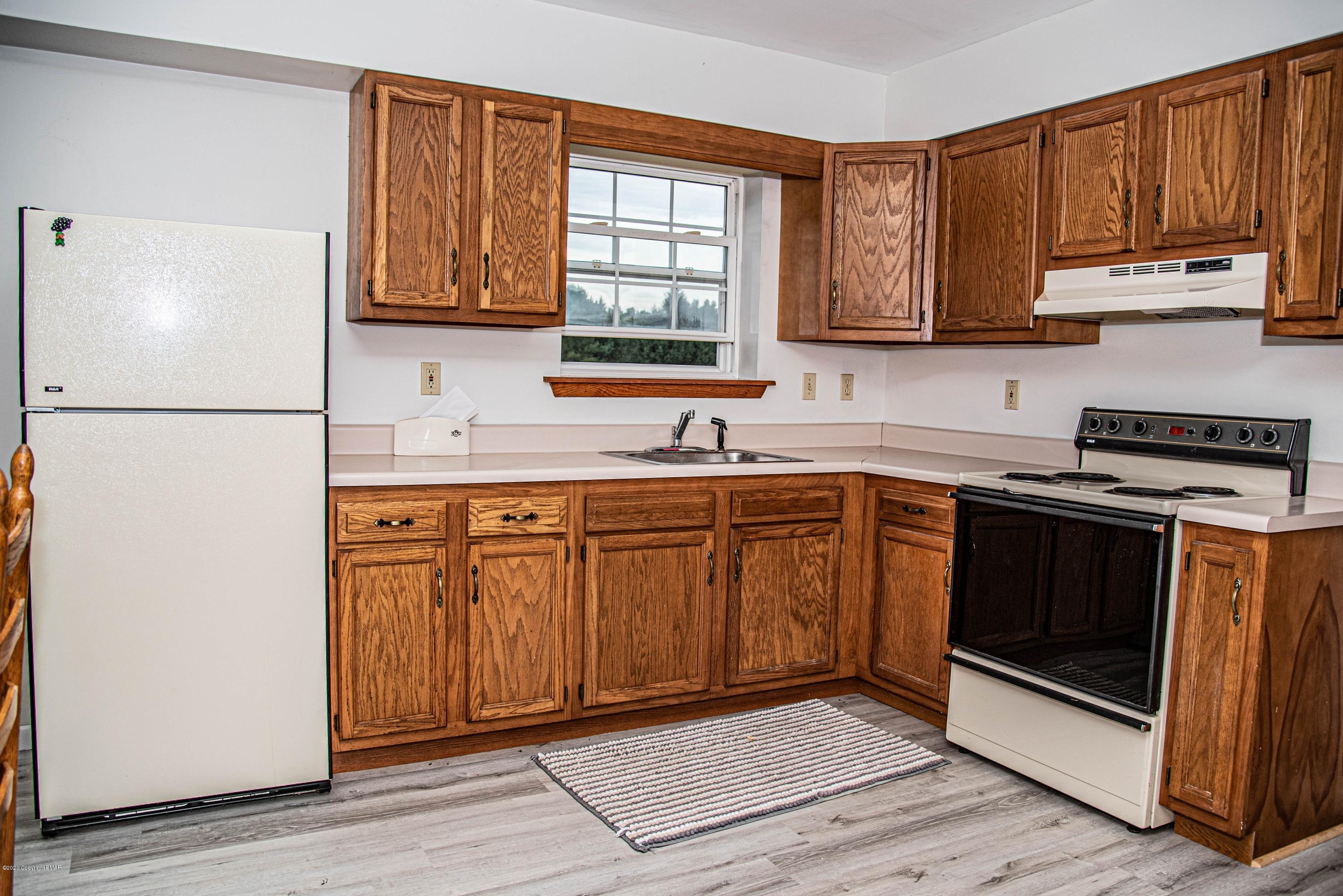 187 Old Stagecoach Road Gilbert, PA 18331 - Photo 29 of 31 a kitchen with a sink a stove and cabinets