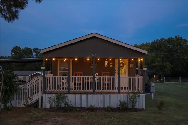a view of a house with wooden deck front of house