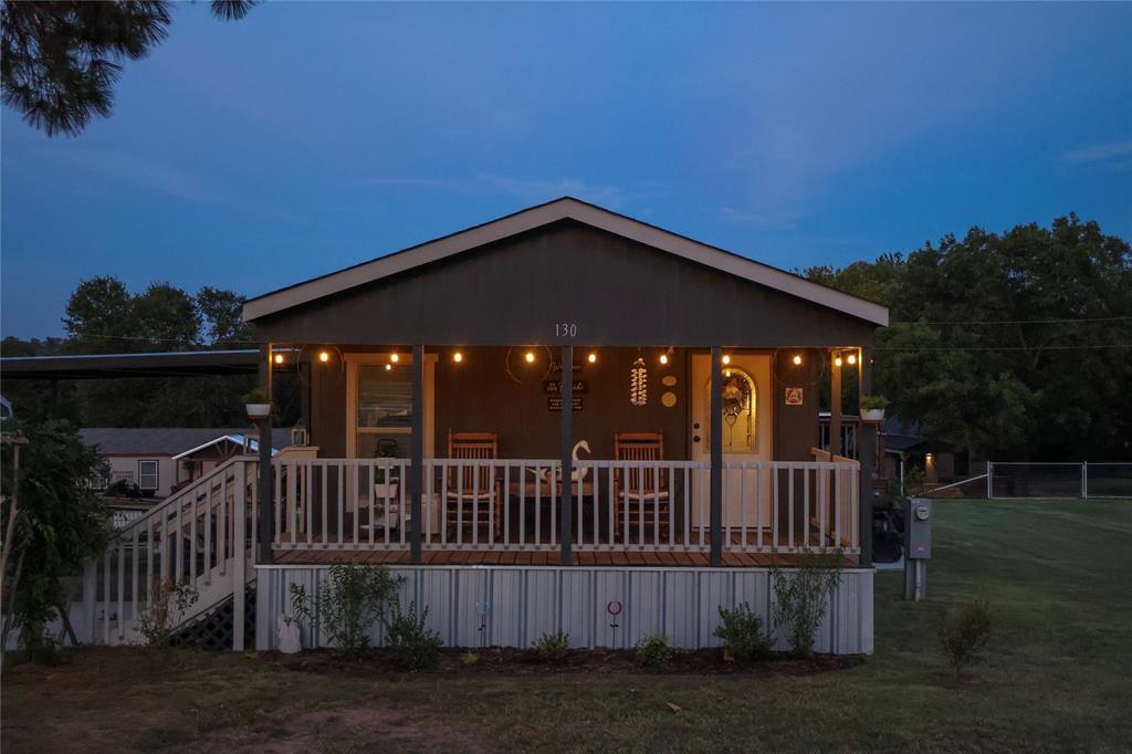 a view of a house with wooden deck front of house