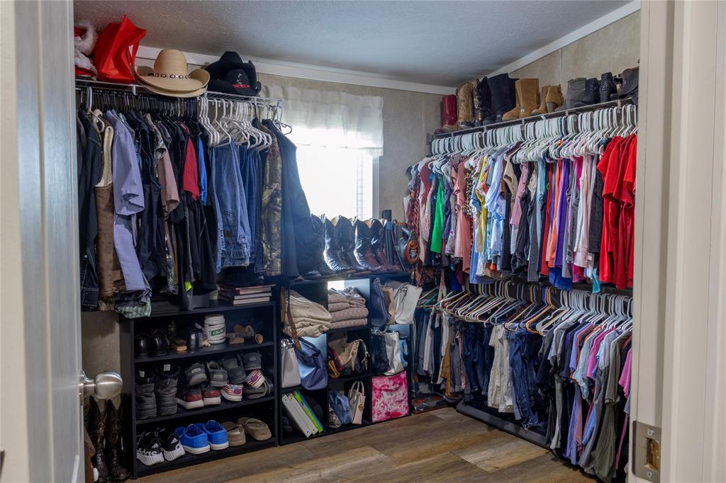 130 Firefly Drive Springtown, TX 76082 - Photo 13 of 25 a view of walk in closet with clothes and shoes