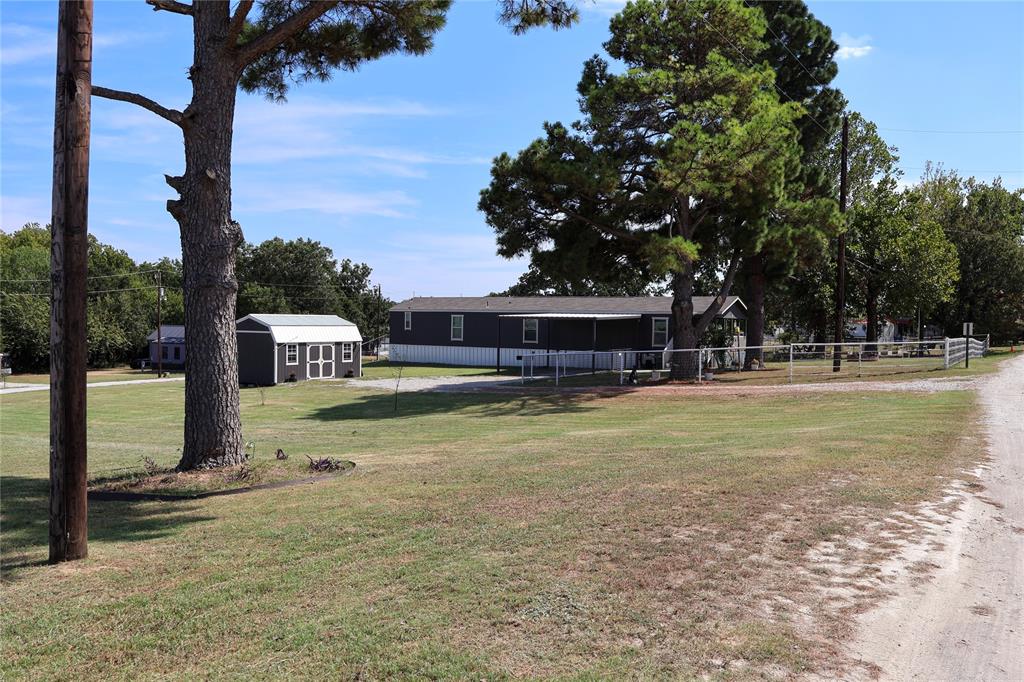 130 Firefly Drive Springtown, TX 76082 - Photo 20 of 25 a swimming pool view with a garden