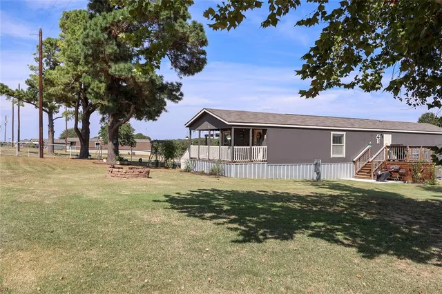 a view of a house with a large tree