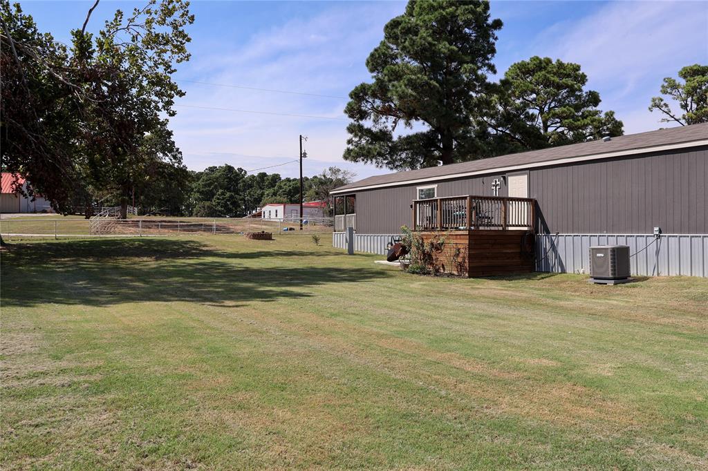 130 Firefly Drive Springtown, TX 76082 - Photo 23 of 25 a front view of a house with a garden and yard
