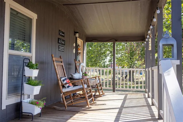 a view of a patio with table and chairs potted plants with wooden floor