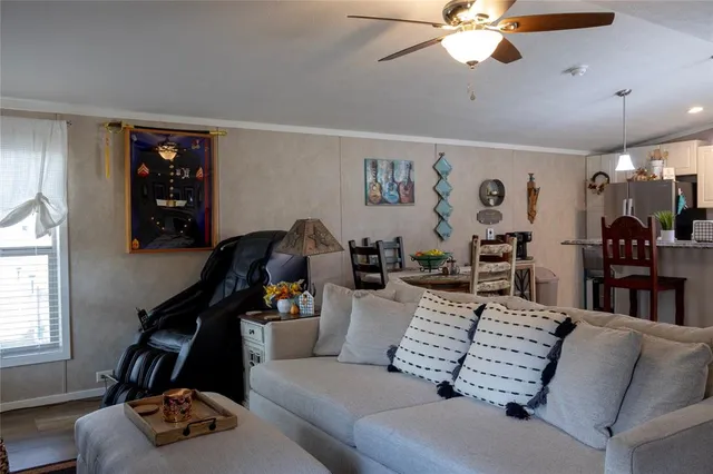 a living room with furniture gym equipment and a window