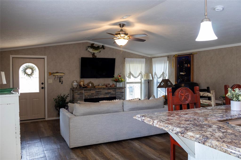 130 Firefly Drive Springtown, TX 76082 - Photo 8 of 25 a living room with furniture and a flat screen tv