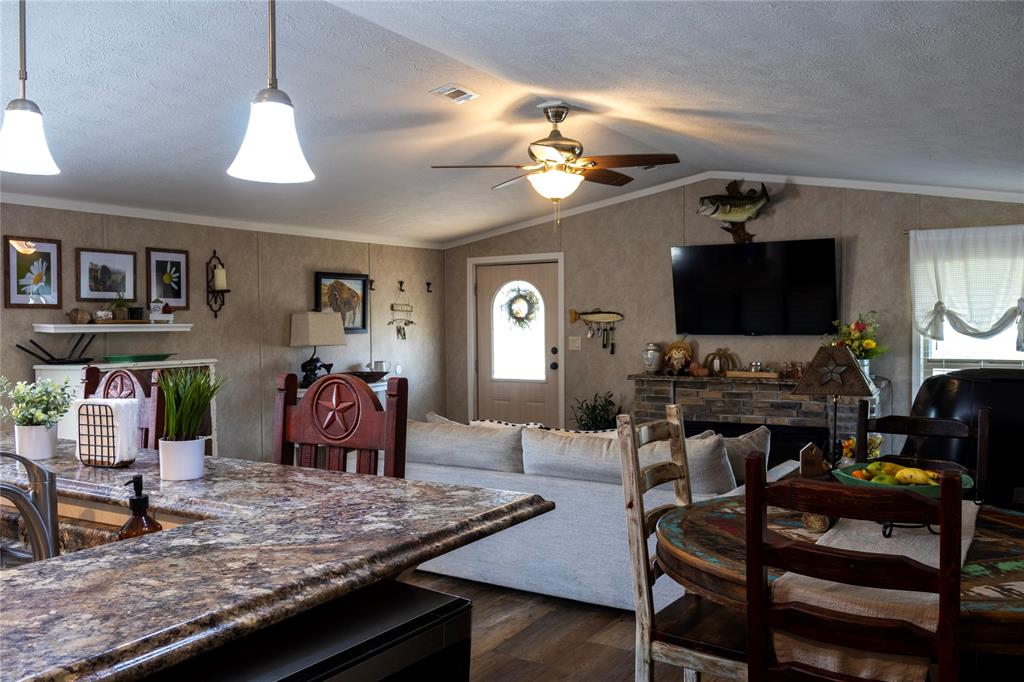 130 Firefly Drive Springtown, TX 76082 - Photo 10 of 25 a living room with furniture and a flat screen tv