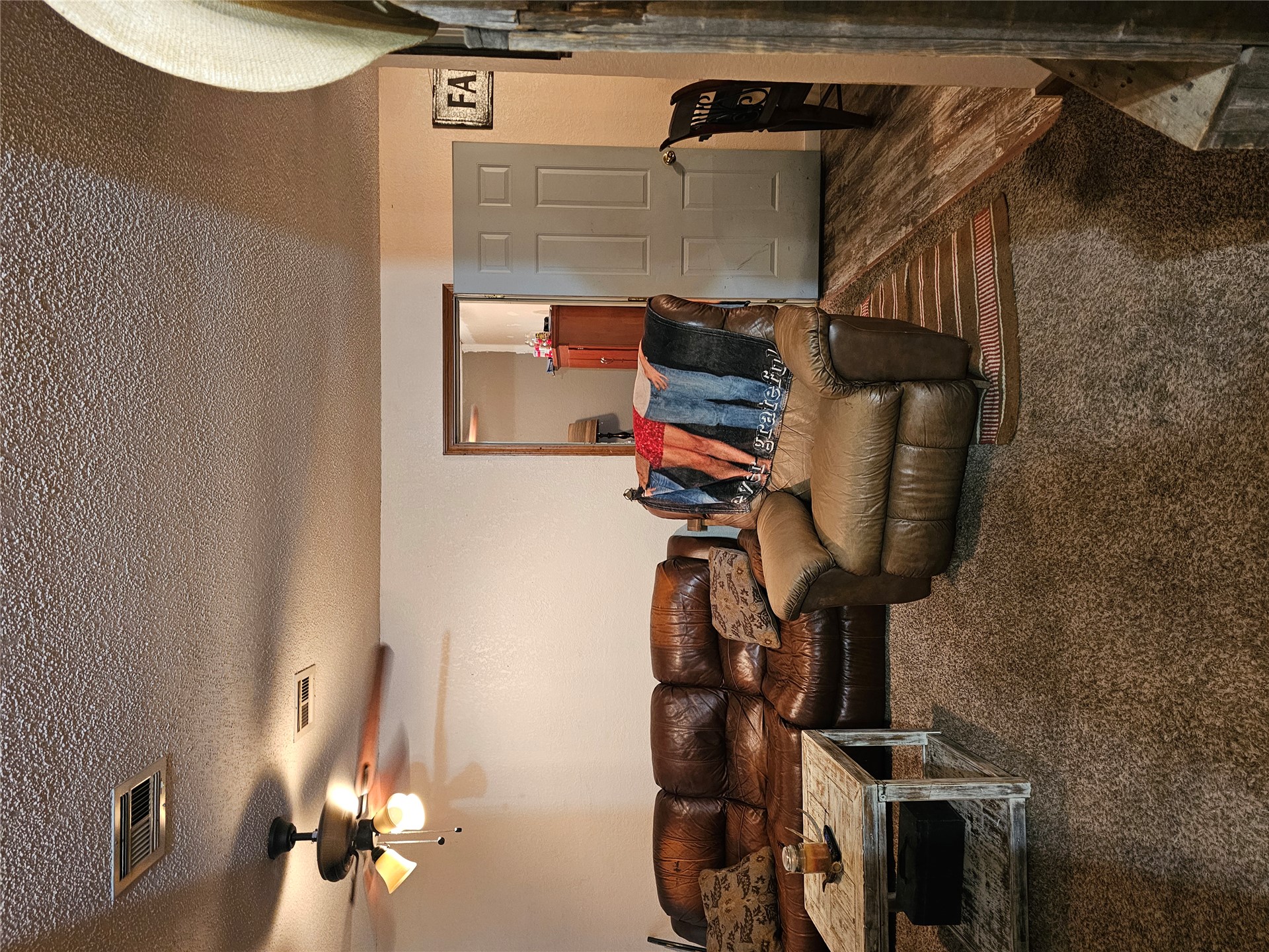 106441 South 4163rd Road Checotah, OK 74426 - Photo 16 of 17 Carpeted living area with a ceiling fan light fixture and a textured ceiling