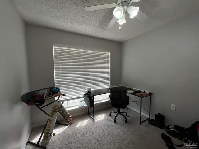 a livingroom with workspace and a window