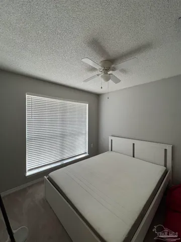 a bedroom with a bed and window