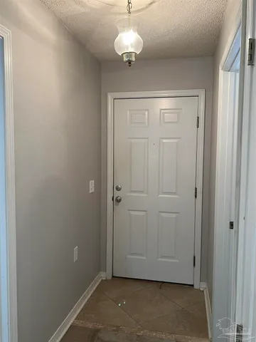 a view of a chandelier fan and hardwood floor