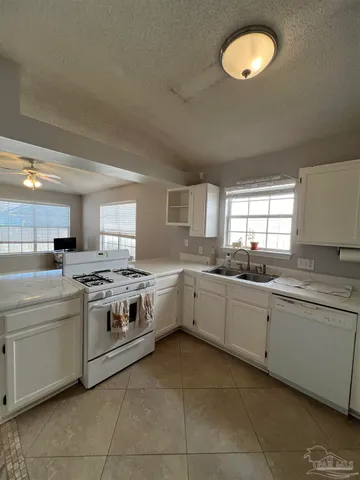 a kitchen with a stove sink and cabinets