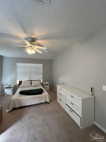 a bedroom with bed and window