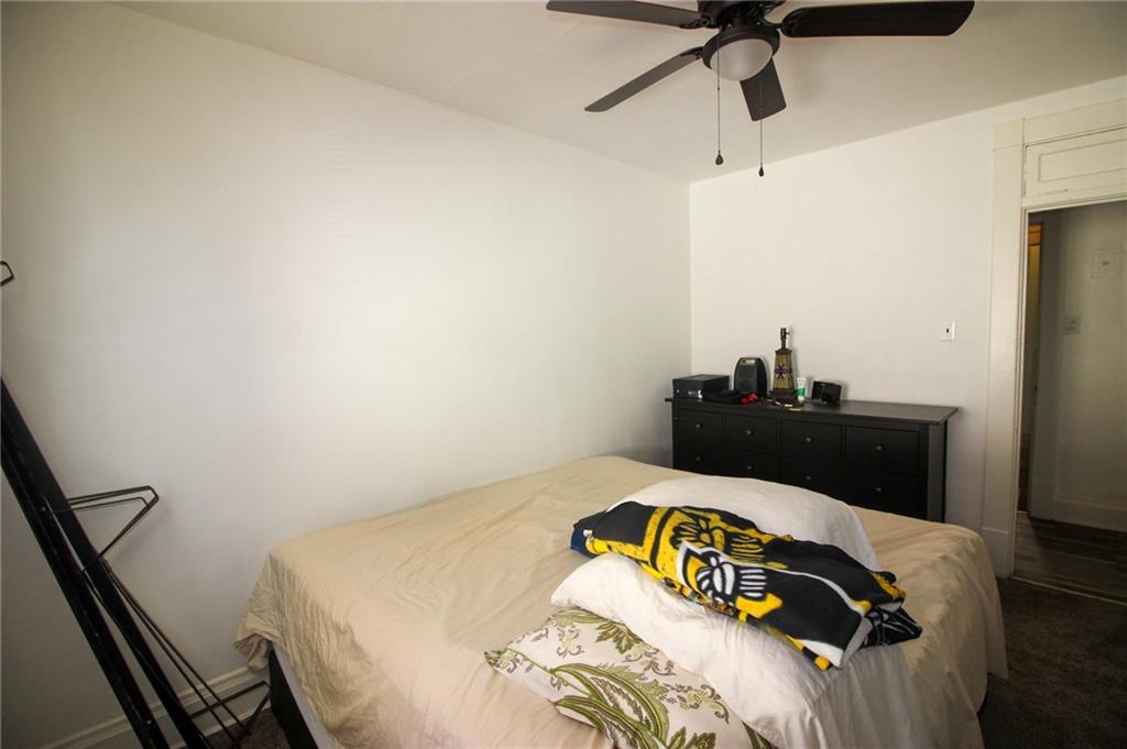 244 Center Street Springdale, PA 15144 - Photo 13 of 32 a bedroom with a bed and a dresser