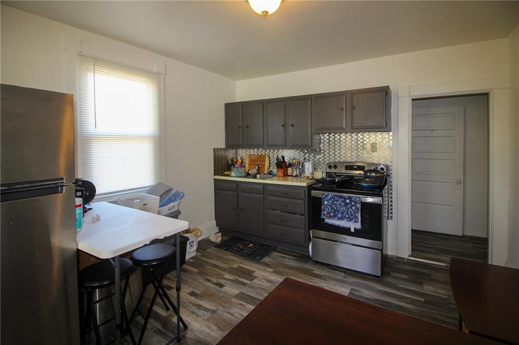 244 Center Street Springdale, PA 15144 - Photo 16 of 32 a kitchen with appliances cabinets and wooden floor