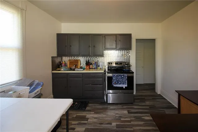 a kitchen with a refrigerator and a stove top oven